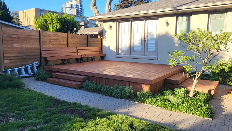 After: brown stained backyard deck and steps with matching privacy screen