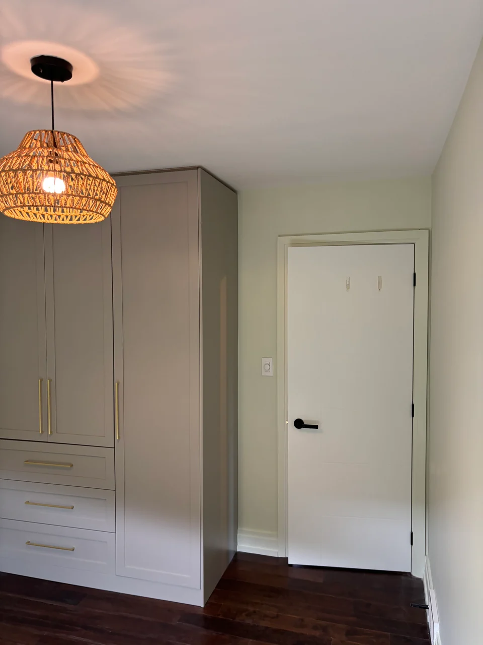 Finished pale walls around fitted wardrobe doors and a white interior door