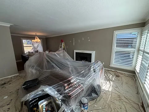 Living room preparation with furniture wrapped and flooring protected